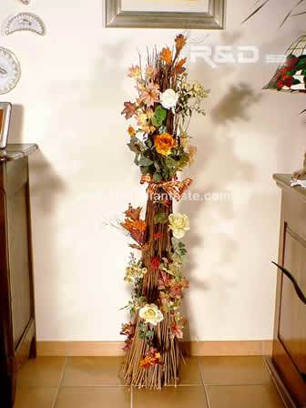 Bundle of twigs decorated for Christmas with iridescente flowers and leaves