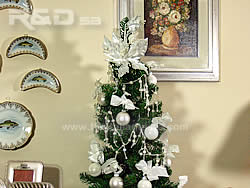 Christmas tree decorated with white balls, bows and crystal chains