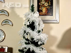 Xmas tree decorated with white feather boa, birds and butterflies