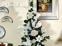 Christmas tree decorated with white birds, flowers and butterflies