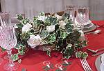 a centerpiece with roses and ivy for Christmas table