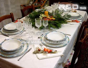 A natural table for Christmas made with pine, candle, dried oranges