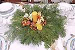 Christmas table ornament, a nice centerpiece made with fresh pine, candle and dried oranges
