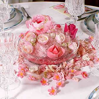 Spring table decorated with pink flowers arranged in a centerpiece