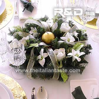 A centerpiece with pine, white roses and orchids for Christmas table