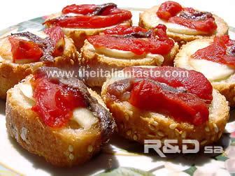 Neapolitan little bruschetta, the photo shows bread slices garnished with tomato pieces, anchovy fillets and mozzarella