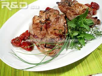 marinated lamb, the photo shows two lamb steaks garnished with aromatic herbs 