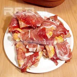 chicken in the brick, details of chicken pieces wrapped in ham slices 