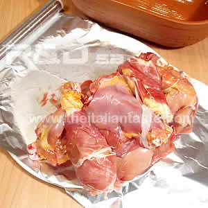 chicken in the brick (pollo alla creta), detail of the chicken pieces before the cooking