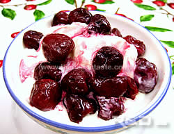 Vanilla ice cream garnished with cherries