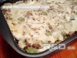 bolognese lasagna in baking pan, the photo shows the surface of lasagna covered by Bolognese sauce and bechamel sauce