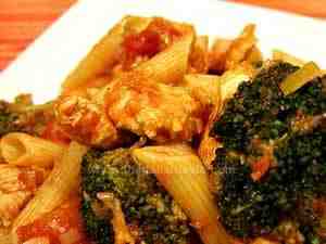 penne with broccoli and chicken breast sauce, the photo shows a detail of pasta dressed with this sauce according the pasta recipe ideas typical of South of Italy