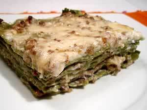Italian lasagna as people make in Bologna, the photo shows a piece of Bolognese lasagna made with green dough, meat-and-tomato sauce and bechamel sauce