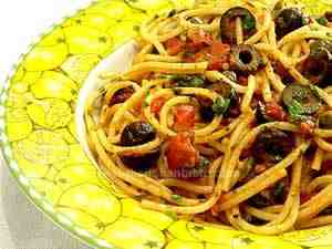Puttanesca spaghetti, spaghetti are tossed with a sauce made with capers, anchovies in oil, olives and tomatoes.