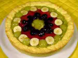 tart with fresh fruit banana, kiwi, white grapes, blackberries and prunes