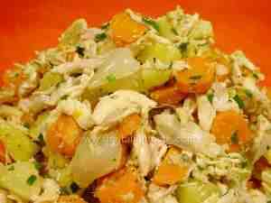 chicken salad with potatoes and carrots in a red bowl