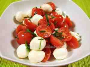 cherry tomatoes and mozzarella cheese, summer salad served in a bowl