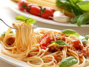 italian pasta with tomato sauce and basil leaves on the top