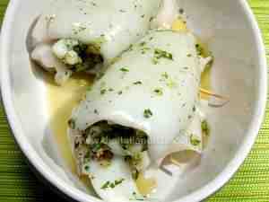 Stuffed cuttlefish-the photo shows the molluscs raw in the baking pan sprinkled with parsley and olive oil
