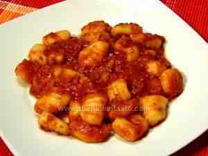 gnocchi (potato dumplings) combined with meat sauce, the photo shows the Italian gnocchi on a white plain dish