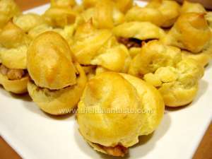 Savory cream puffs filled with mushrooms and shrimps in a white platter