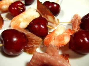 prans, cherries and salami on skewers