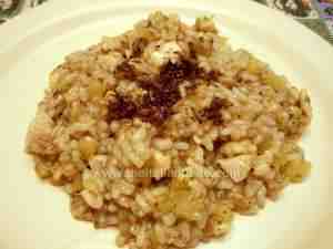 Risotto with chicken, potatoes and truffles served in a plate