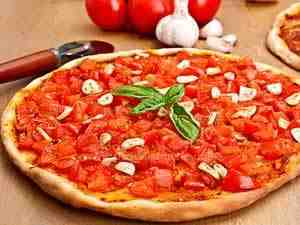 Pizza with garlic and tomatoes on the top