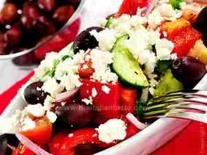 Vegetarian salad with cucumbers, peppers, tomatoes, feta cheese, onions and tomatoes
