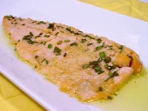 Steamed salmon trout fillet in a serving dish