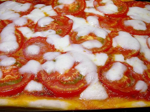 Pizza with ripe tomatoes