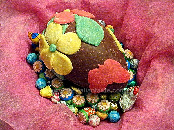Marzipan flowers and butterflies on a chocolate egg