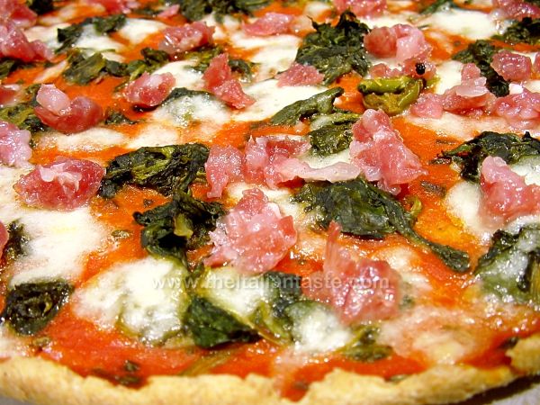 Pizza with salami and spinach